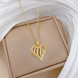 Titanium steel heart pendant necklace with hollow design and crystals on beige silk fabric