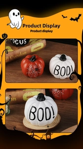 Detail of Halloween resin pumpkins with spider web motif and BOO text on wood surface