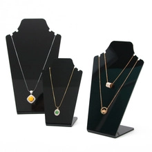 Three-piece set of black acrylic necklace display stands in tiered heights for jewelry