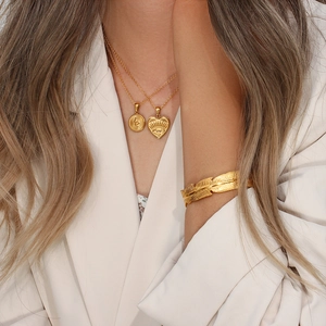 Minimalist 18K gold plated feather cuff bracelet and layered pendant necklace set on model