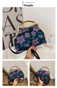 Detail of vintage navy fabric handbag with purple floral embroidery and resin handle
