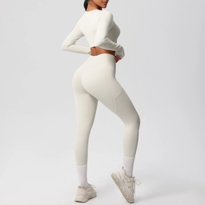 Detail of high-waisted yoga pants with side pockets and slimming fit in creamy white