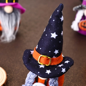 Detail of Halloween gnome wizard hat with star patterns and vibrant orange belt buckle