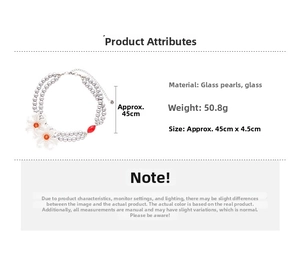 Detail view of double-layer glass pearl necklace with floral accent and red bead ornament