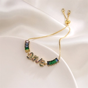 Detail of gold LOVE bracelet with colorful micro-pave zircons and adjustable slider clasp