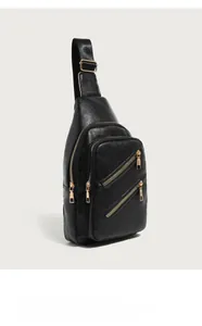 Detail of black litchi texture PU leather chest bag with three golden metal zippers