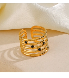 Detailed view of adjustable multi-layer gold ring with black enamel dots on silk