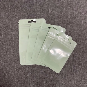 Detailed view of matte light green frosted resealable bags with hanging holes in various sizes