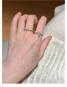 Detailed view of s925 silver rings with pearls, blue floral and star-shaped charms