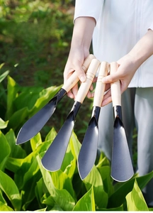 Garden shovel set with black metal heads and wooden handles for outdoor planting use