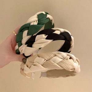Three stylish braided headbands in green, black, and beige textures for women