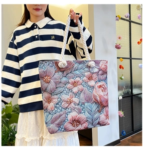 Detail of floral embroidery canvas tote bag with thick rope handles and spacious interior