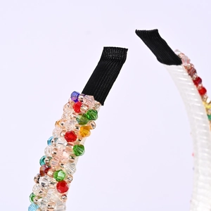 Detailed close-up of colorful crystal beads and black fabric end on the headband