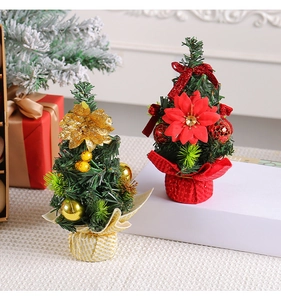 Detailed view of mini artificial Christmas trees with gold and red floral decorations