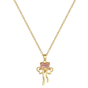 Pink heart crystal and golden bow necklace with fine chain for women on white background