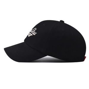 Detail of white embroidery on a black cotton baseball cap with a curved brim design