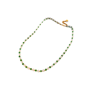 Elegant gold-plated pearl necklace with green gemstones and white beads on white background
