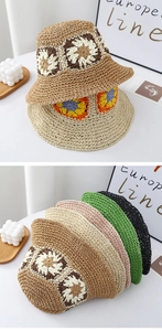 Detailed close-up of handmade crochet flower patterns on woven summer straw bucket hats