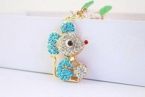 Detail of a gold mouse keychain featuring sparkling blue and clear crystal rhinestones
