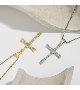 Close-up of minimalist cross pendants featuring gold and silver plating with cubic zirconia