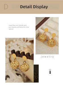 Macro shot of 18K gold plated hollow bead earrings with inlaid zircon on warm background
