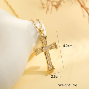 Detailed view of a gold cross pendant with heart center and zircon showing 4.2cm height