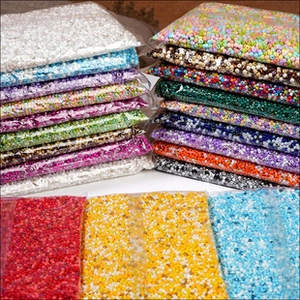 Macro shot of colorful glass seed beads sorted in clear plastic bags for DIY jewelry