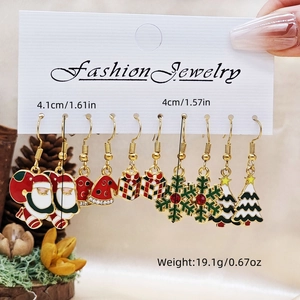 Detailed view of five pairs of Christmas earrings including Santa and Snowman sets