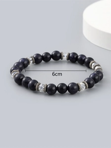 Blue sand stone beaded bracelet with silver spacers on a minimalist background, 6cm diameter