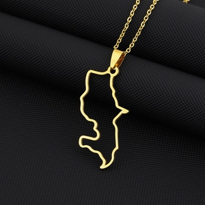 Detailed macro view of the gold-plated Martinique island outline pendant on a delicate chain