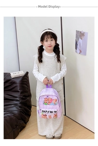 Close-up of kids purple checkered backpack featuring cute cartoon capybara prints