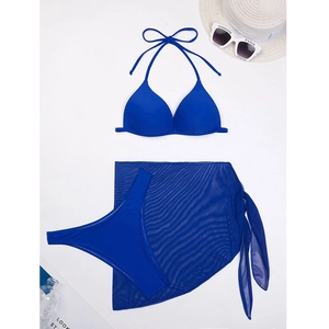 Flat lay of electric blue 3-piece bikini set with sheer mesh sarong and beach accessories