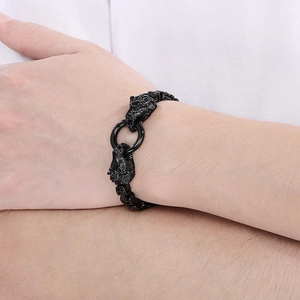 Detail of vintage lion head link bracelet in black steel on a male wrist