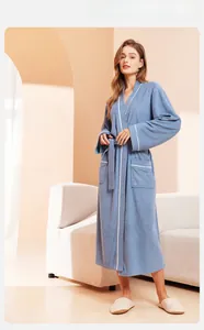 Light blue full-length bathrobe detail with contrast piping and textured fabric