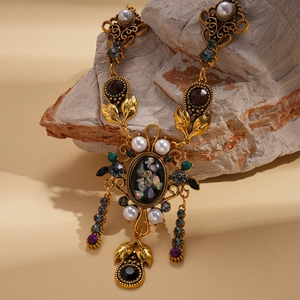 Detailed view of vintage pendant featuring resin diamonds, pearls and a shell mosaic