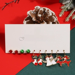 Detailed close-up of 5-pair Christmas earring set with snowman and reindeer charms
