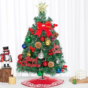 Close-up of a 60cm mini desktop Christmas tree with red berries, pine cones and ornaments