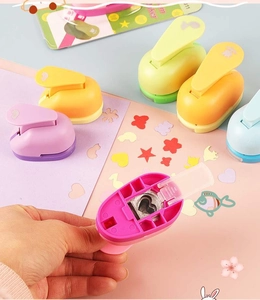 Close-up of colorful DIY paper punches showing diverse patterns like hearts and stars