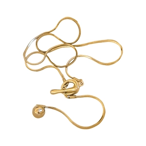 Minimalist gold snake chain necklace with a stylish OT toggle clasp on a white background