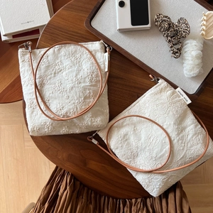 Beige cotton linen crossbody bag with floral embroidery and brown leather strap