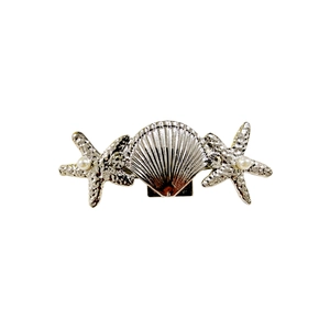 Detail of silver shell and starfish hair clip with pearls and rhinestones on white background