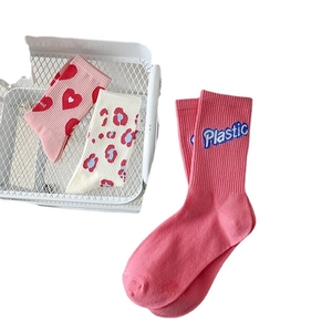 Three-pack of pink and beige cotton mid-calf socks with heart, leopard, and text patterns