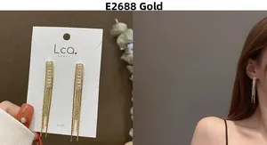 Detail view of gold tassel earrings with zircon studs and elegant silver post detail