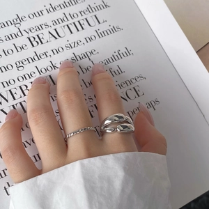 Close-up of minimalist silver double-layer smooth rings with a modern streamlined design