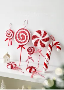 Macro view of red and white glitter candy cane ornaments with ribbon bows for Christmas