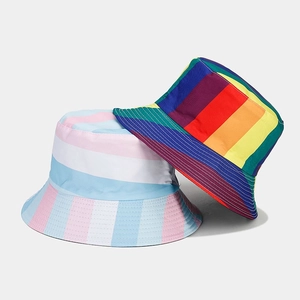 Close-up of rainbow and pastel striped bucket hats showing fabric texture and vibrant colors