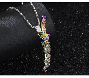 Detail of colorful dragon sword pendant with black gemstone on stainless steel chain