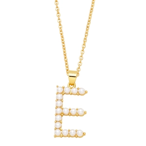 Macro shot of gold letter E pendant featuring inlaid white pearls and a fine chain