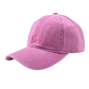 Detail view of pink washed cotton baseball cap with vintage distressed texture and curved brim