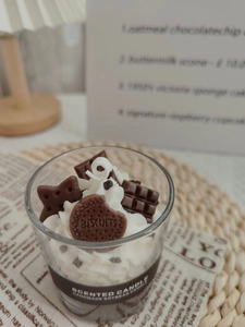 Detailed close-up of handmade strawberry chocolate soy candle with biscuit decoration